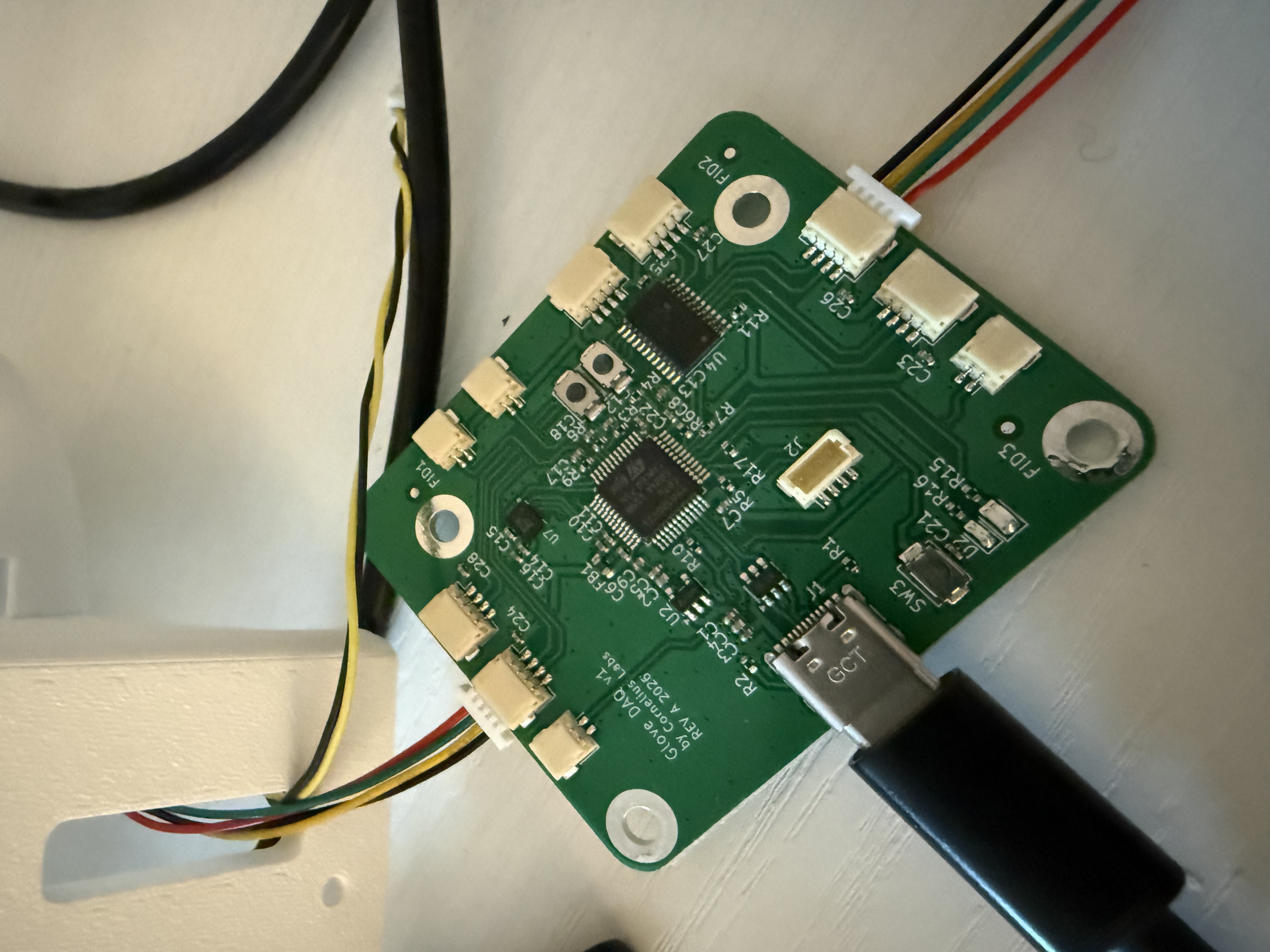 The DAQ board. STM32G431 + TCA9548A I²C mux + QMI8658C IMU. Four MLX90393 Hall sensor PCBs and two VL53L1X ToF sensors connect via JST headers around the perimeter. Designed in KiCad, manufactured at JLCPCB.
